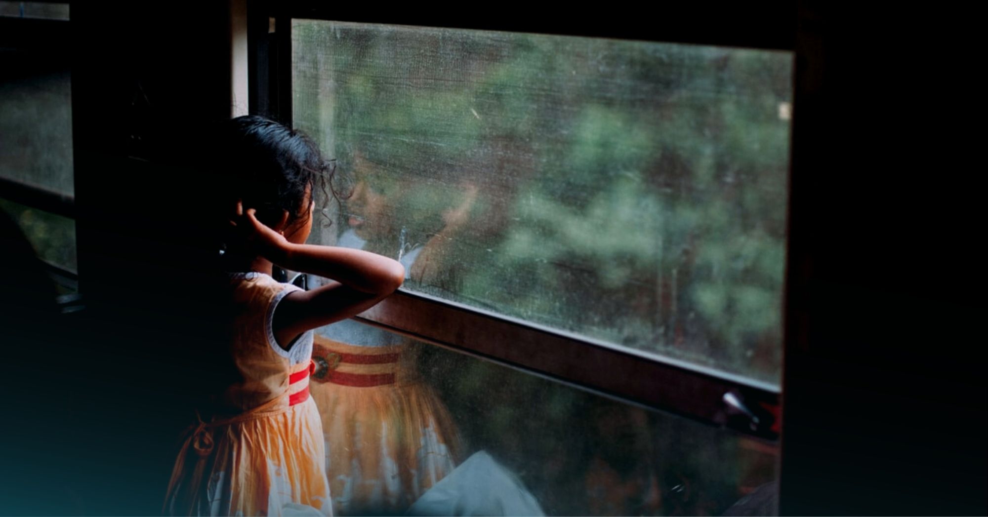 Sri Lankan girl looking out the window