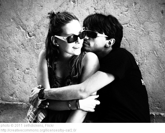 couple wearing sunglasses and hugging